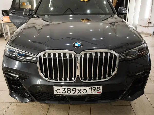 Чёрный BMW X7 после полировки царапин — глянцевый капот и хромированная решётка радиатора